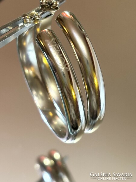 A pair of larger silver hoop earrings with a clean shape