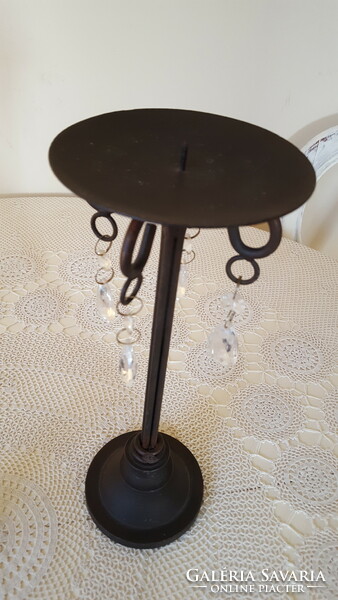 A pair of wrought iron candle holders with crystal glass pendants