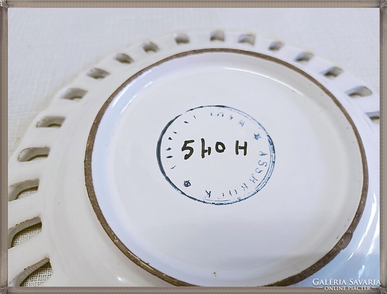 Handcrafted ceramic decorative plate with an openwork edge.