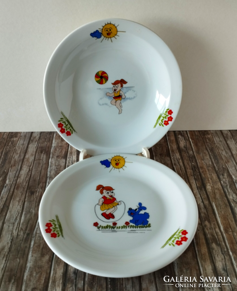 A set of porcelain children's flat and deep plates with a fairytale pattern