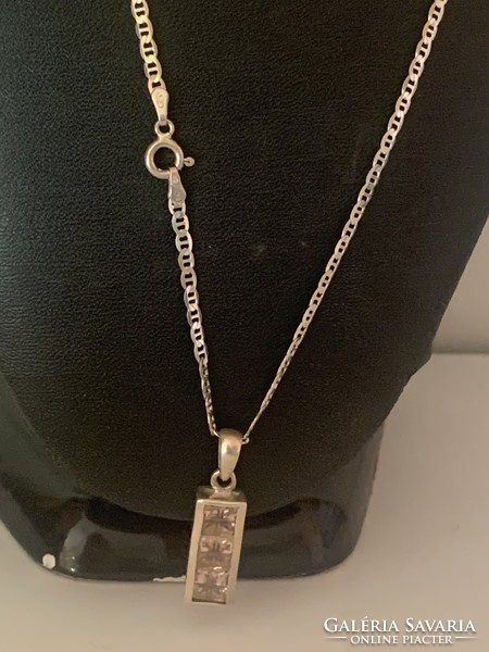 Signed with a silver pendant chain