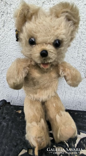 Antique retro teddy bear marked on the ear with a toothed wien, straw teddy bear