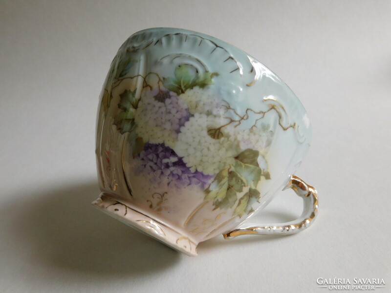Antique tea cup with ball rose pattern - a nick on the rim