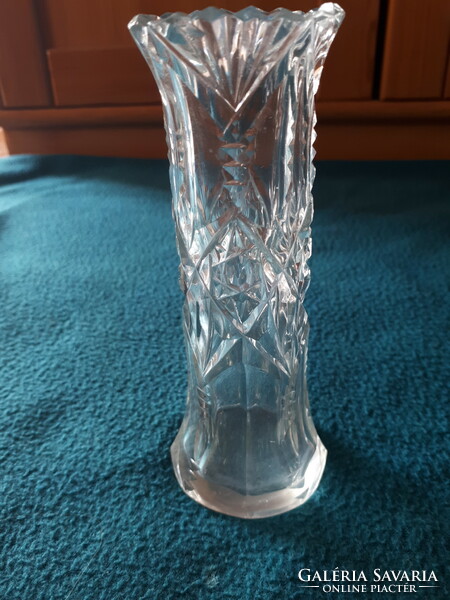 Antique cast-polished glass vase with a strand of flowers