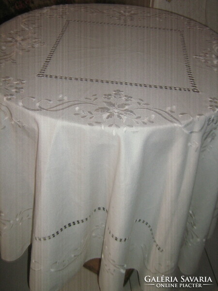 Beautiful white vintage floral machine-embroidered round tablecloth with a slinged edge