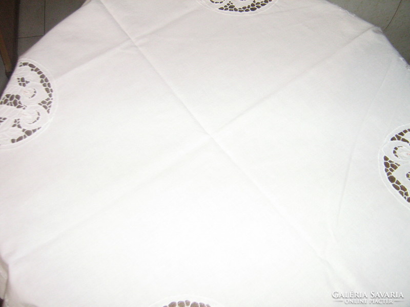 Beautiful white rosette tablecloth with a Christmas pattern in the four corners