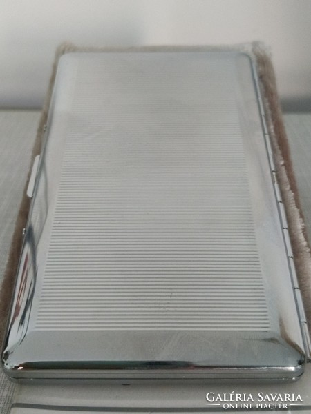Stylish metal cigarette case with a striped engraved pattern