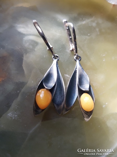 Old silver earrings with amber