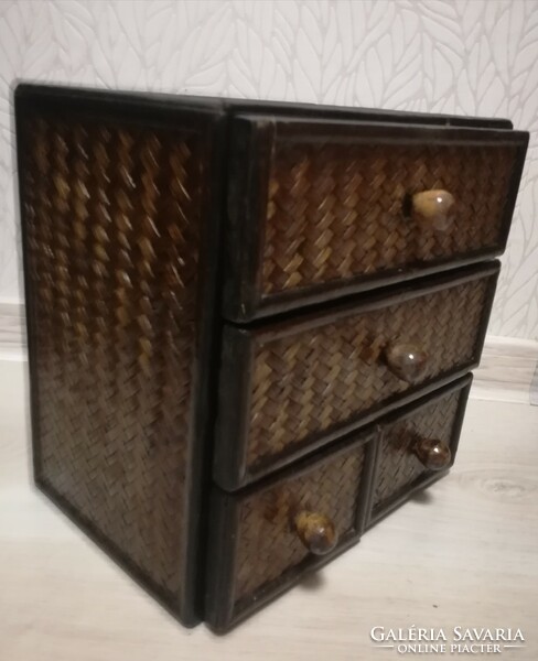 Small storage cabinet made of wood with 4 rattan drawers