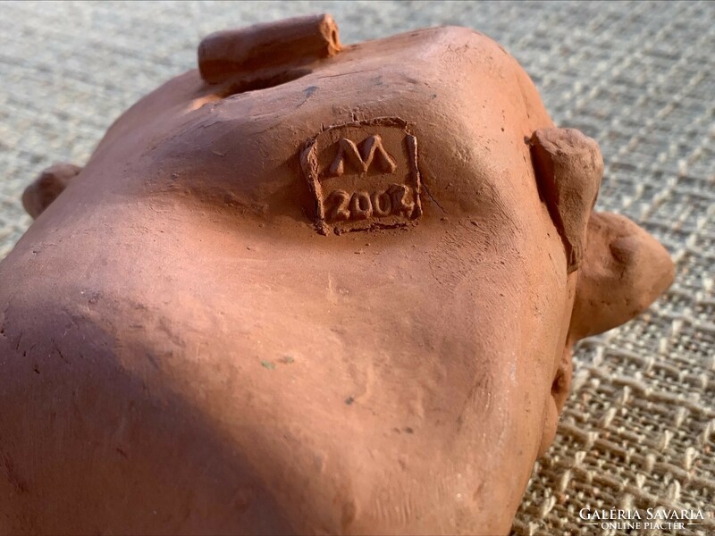 Marked terracotta cow head, mark m 2002.