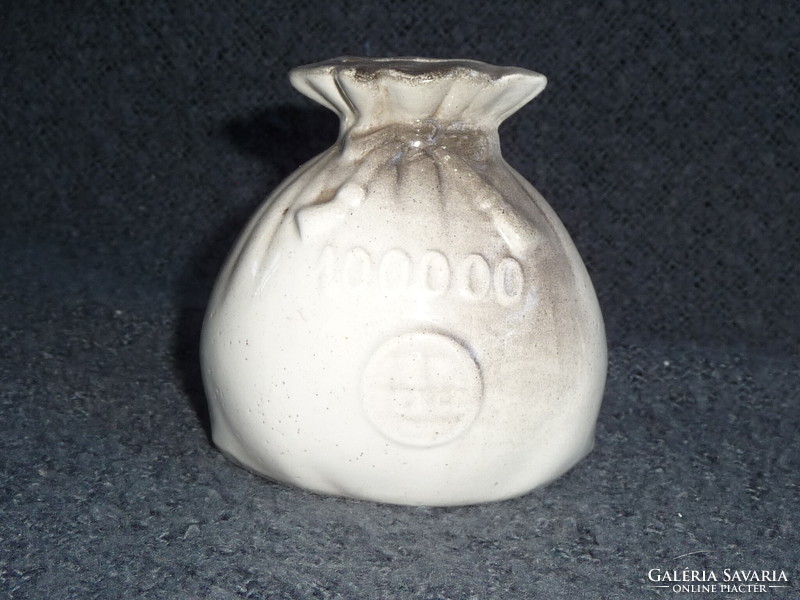 Old porcelain socket in the shape of a money bag. Earthenware socket in the shape of a money bag. 100-year-old socket figure