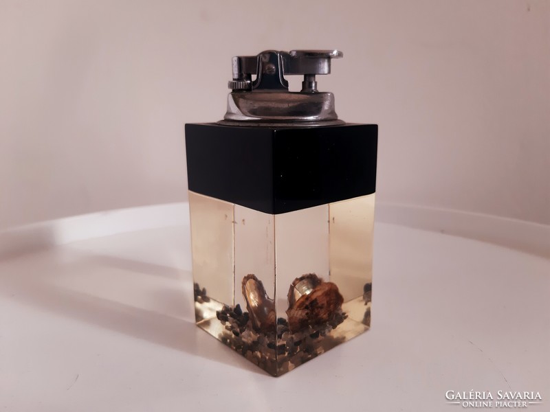 Glass lighter decorated with old shells