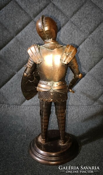 Nicely crafted metal knight armor! Sword and shield in hand! Coat of arms on the shield and also on the breastplate!