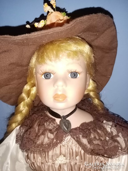 Porcelain doll with blonde pigtails