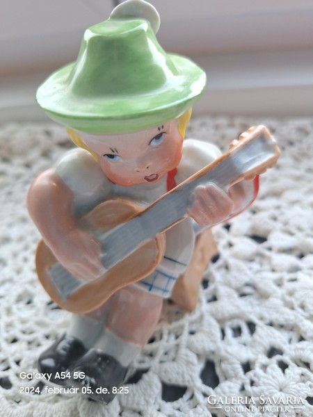 Porcelain figurine of a boy playing guitar