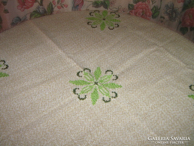 Light beige woven tablecloth embroidered with beautiful green