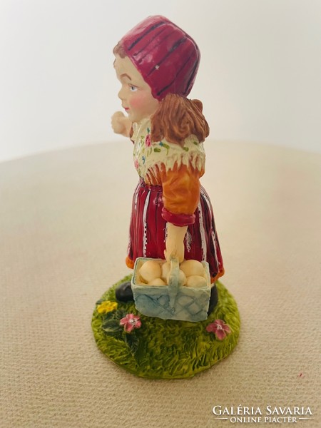 Ceramic figural sculpture: a little girl in a red headscarf with a basket of eggs