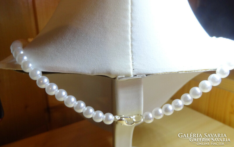 Necklaces made of white rose pearls and white shell pearls.