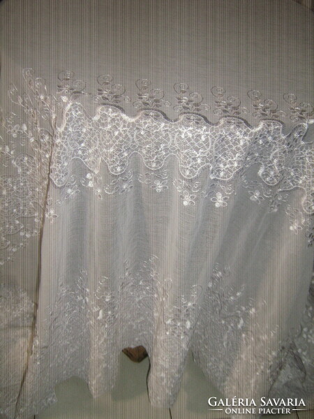 A curtain with flower embroidery in a fairy-tale white material