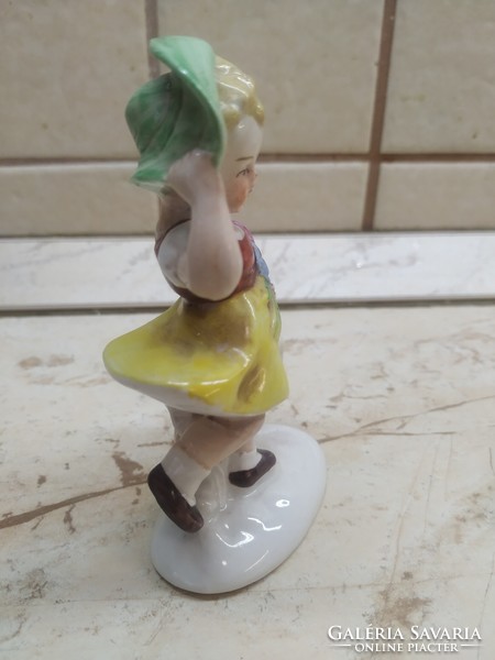 Little girl in a green hat with a toy statue! Antique porcelain statue, marked and numbered at the bottom for sale!