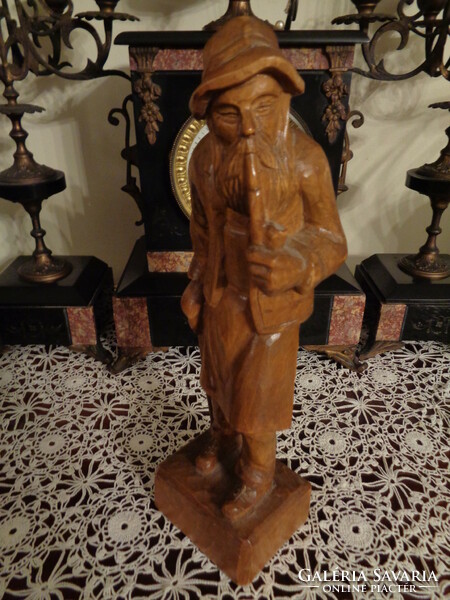 Vintage wooden carved statue of a piper