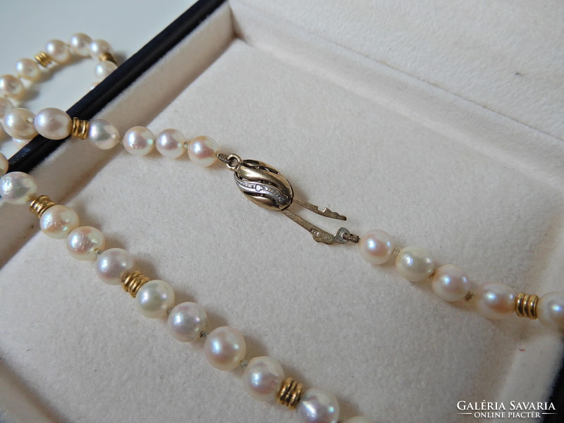Old string of real pearls with 8 carat gold lock and diamonds