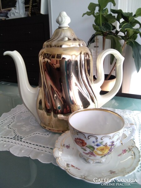 Large porcelain warming tea and coffee pot covered with a chrome-plated thermo jacket.