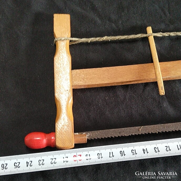 Retro toy saw - old carpenter's hand saw with a wooden frame