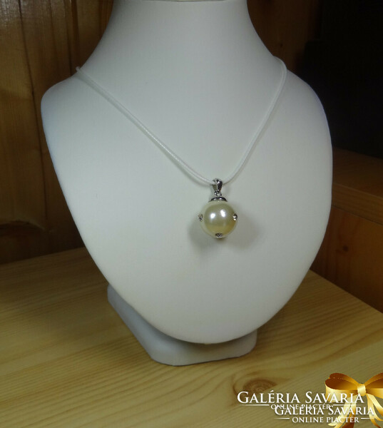 A very beautiful pendant made of shell pearls, decorated with 4 cubic zirconia stones + white chain.