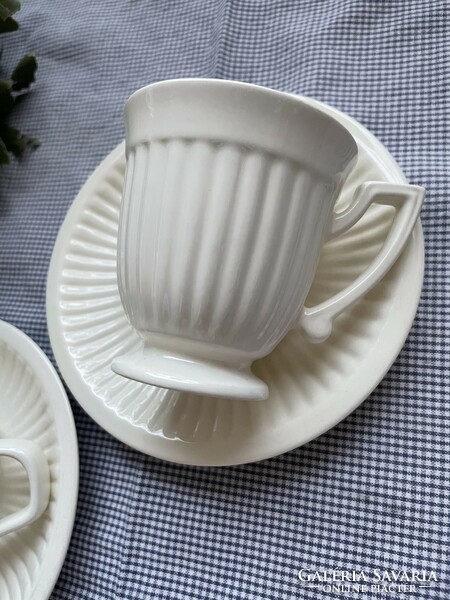 Cream-colored small mug with a wonderful rim design, empire ribbed walls, clean lines