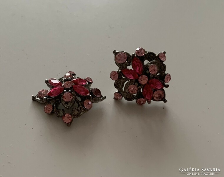 Silver colored metal clip earrings studded with pink colored stones
