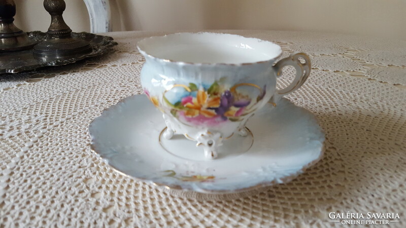 Beautiful antique cup and saucer with zigzag edges standing on legs