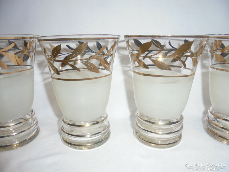 Six pieces of old glass goblets with a richly gilded leaf design