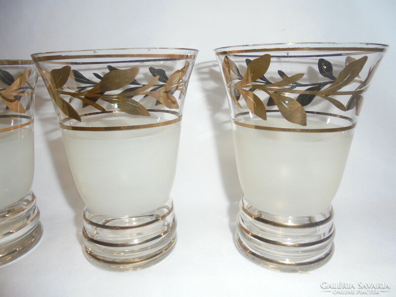 Six pieces of old glass goblets with a richly gilded leaf design