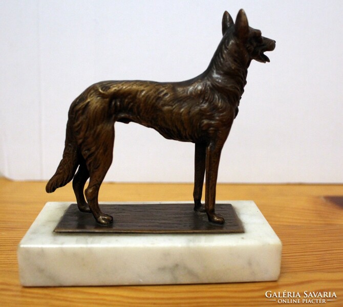 Copper Malinois dog statue on a marble plinth