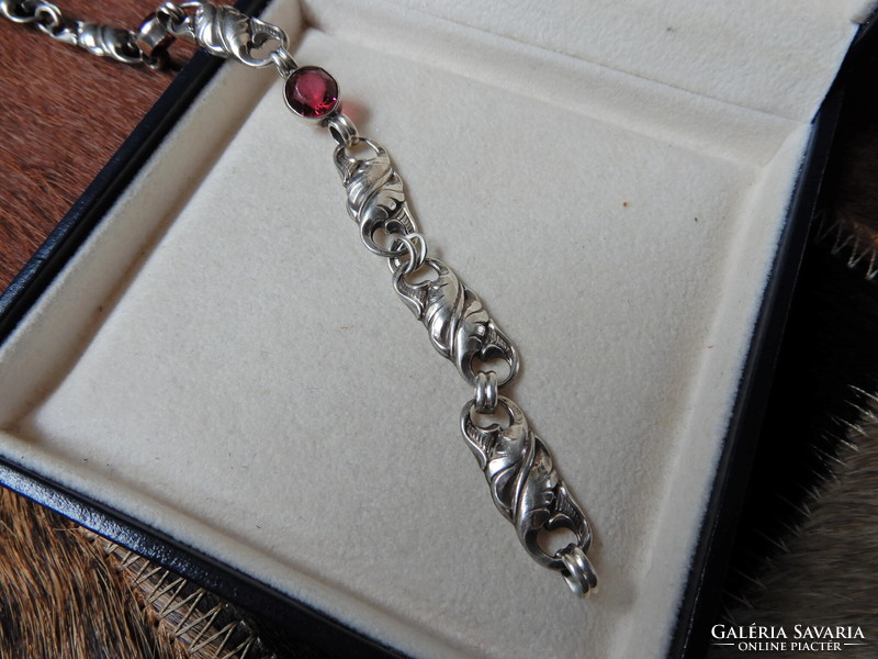 Old silver bracelet with ruby colored stones