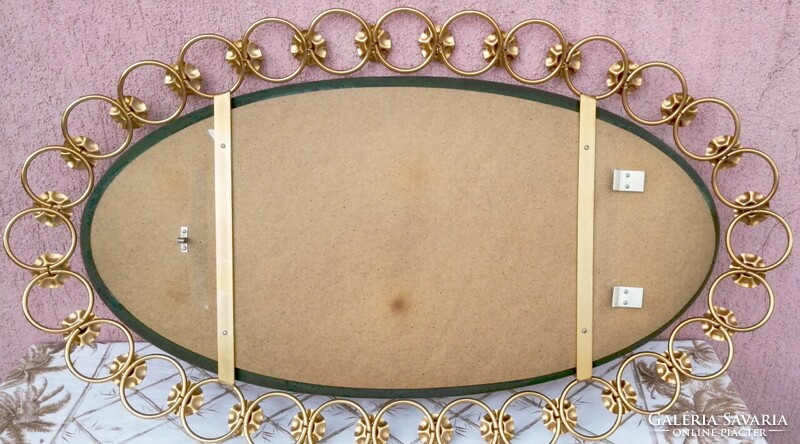 A modern art object. Gold-plated metal frame oval mirror in perfect condition