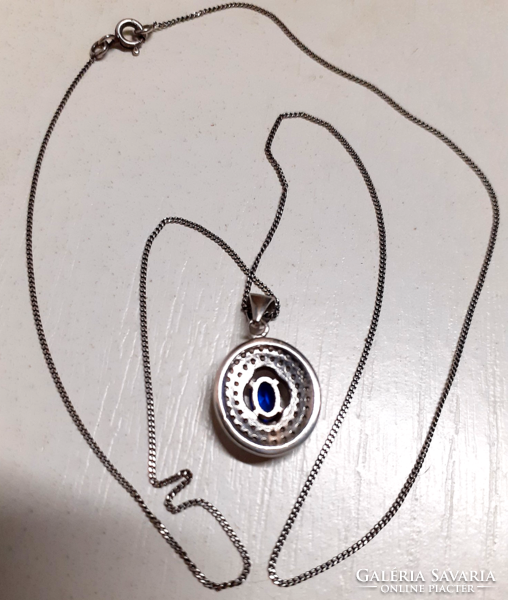 Marked silver necklace with a silver filled sapphire blue circle pendant studded with white zirconia stones