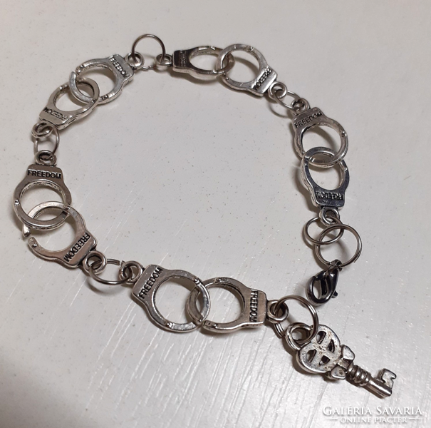 Beautiful silver-colored freedom stainless steel handcuff bracelet with small key locket