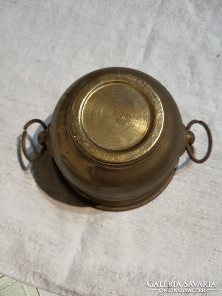 Antique copper pot with lion head handle.