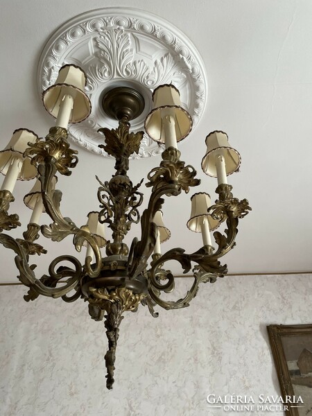 A bronze chandelier and two bronze wall arms