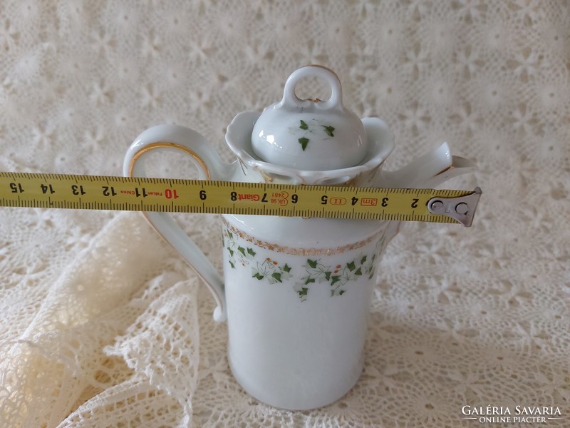 Old porcelain small jug with leaf pattern spout