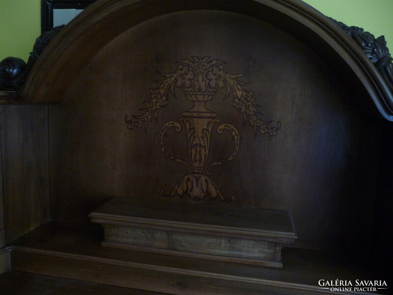 A dining set decorated with neo-baroque style features and a carved structure, from the first half of the 20th century.