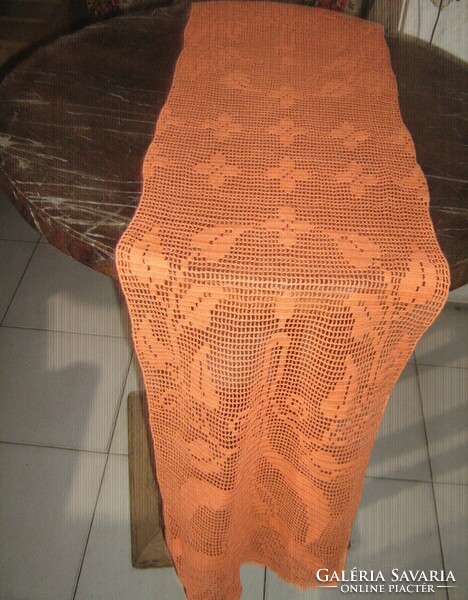 Beautiful, hand-crocheted orange-colored floral tablecloth with candles and leaves, large runner