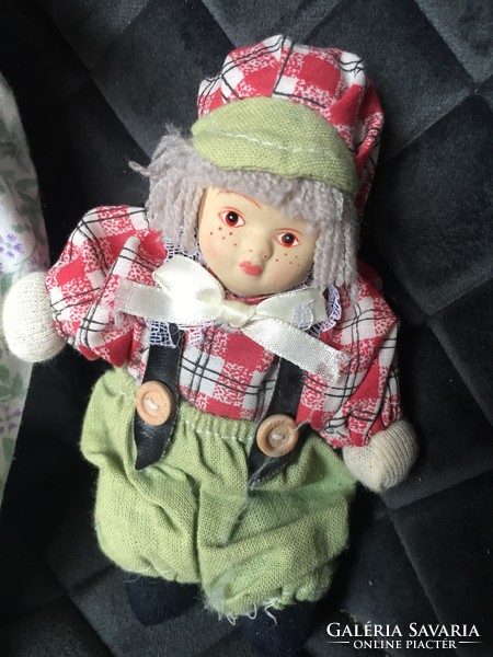 An old, vintage porcelain doll, a porcelain doll, a small doll in one - unfortunately damaged