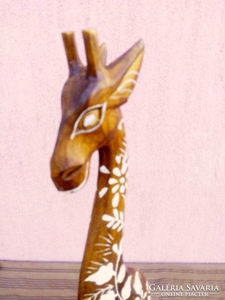 Exotic handmade decoration. Painted ornate giraffe wooden sculpture from Indonesia