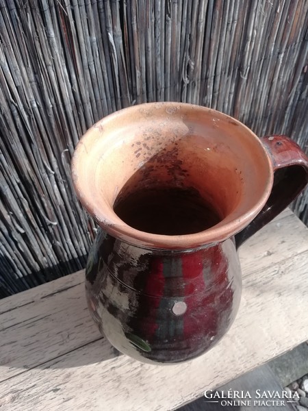 Old brown jug with floral pattern