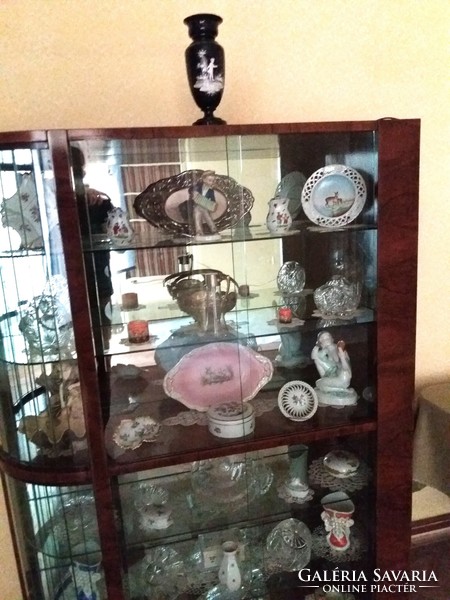 An old showcase with many beautiful objects in it