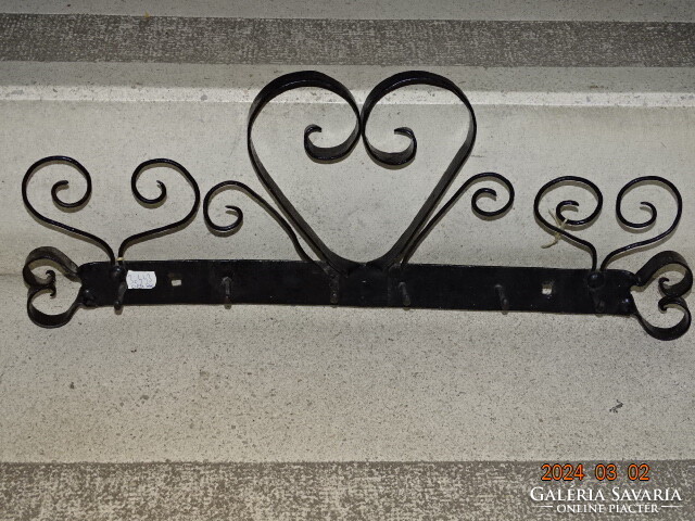 Old decorative wrought iron wall hanger