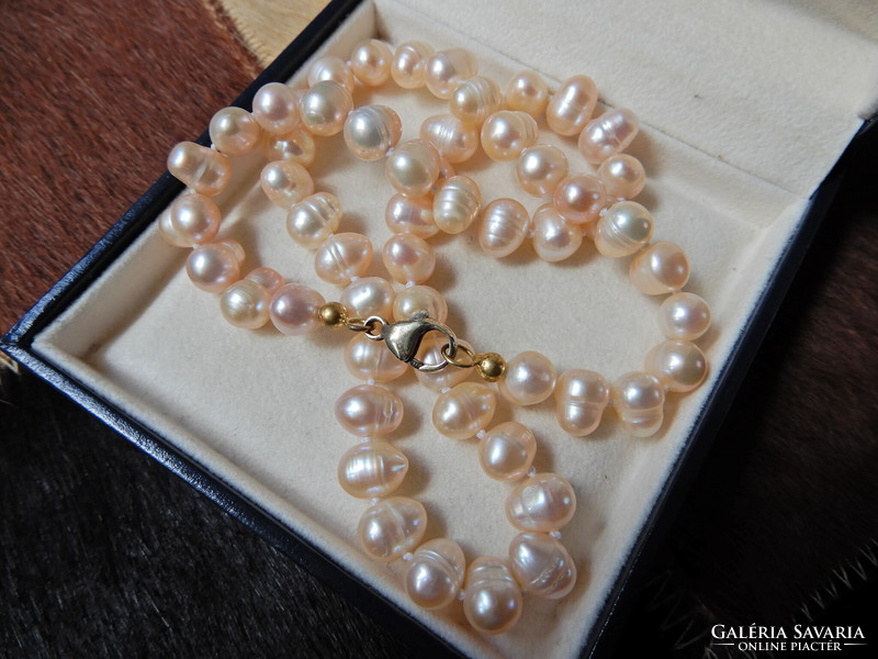 A string of cultured freshwater pearls with a gold-plated silver clasp